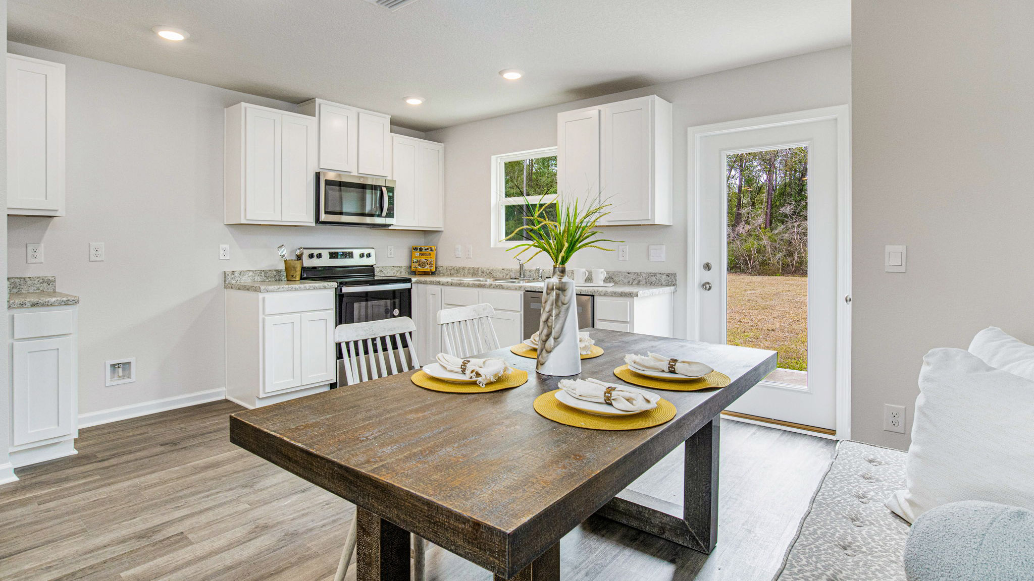 The Allanton floorplan kitchen with white shaker cabinets and Formica countertops