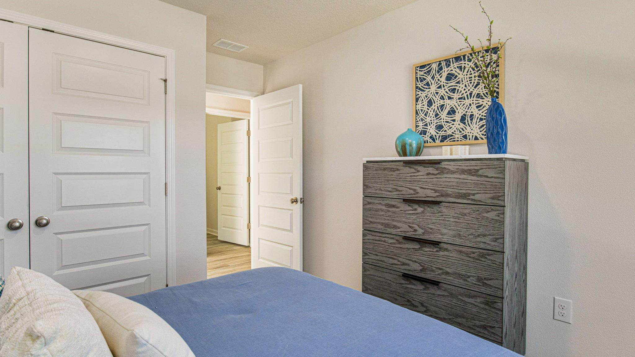 The Callaway floorplan guest bedroom one with EVP flooring throughout