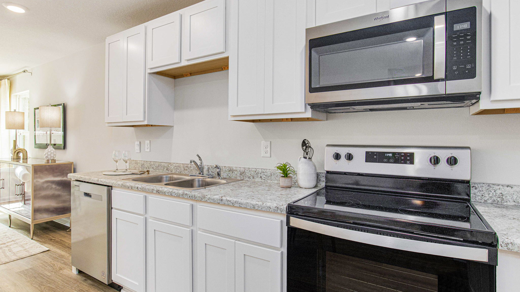 The Sullivan floorplan kitchen with white shaker cabinets and Formica countertops