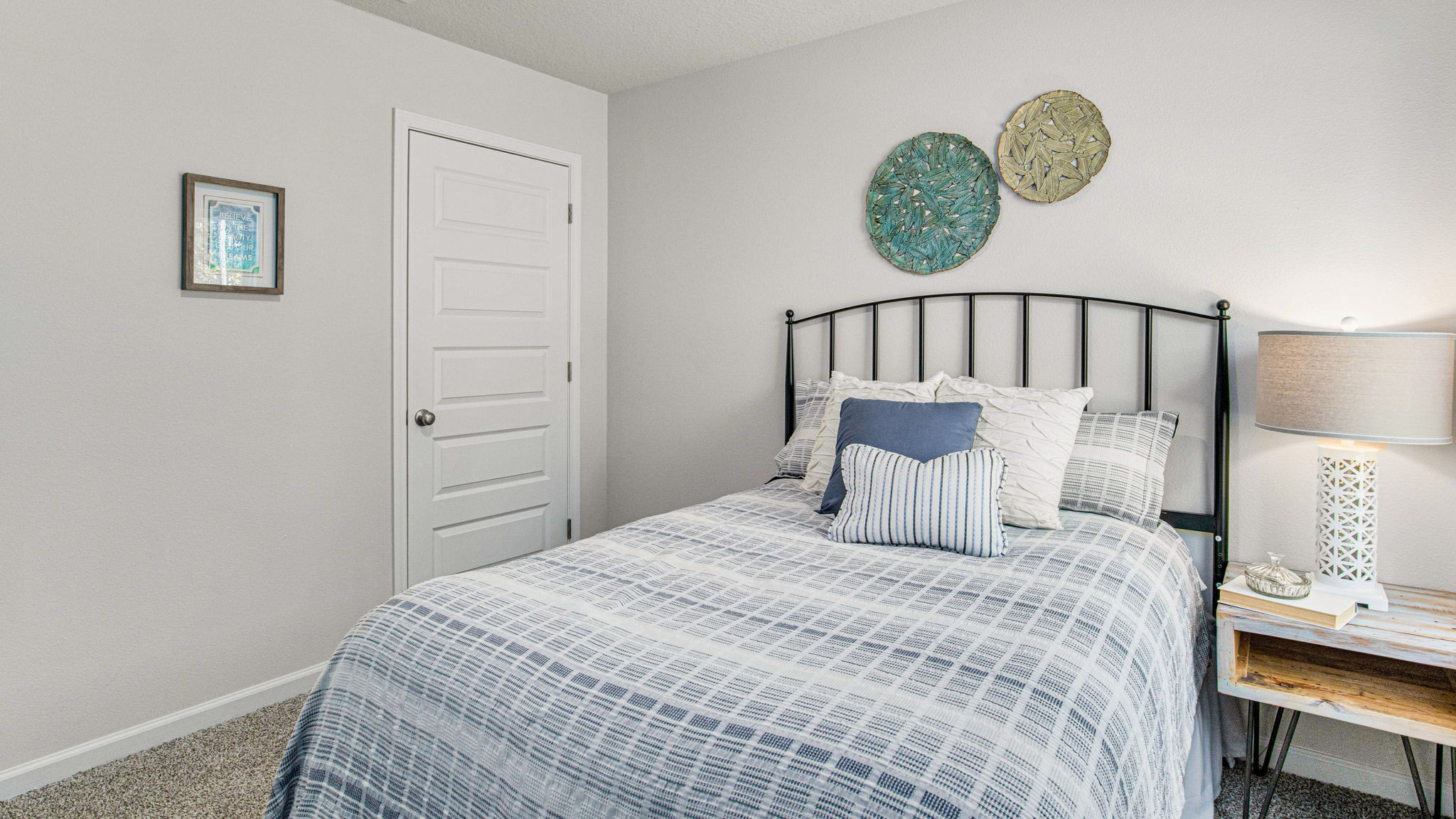 The Cali floorplan guest bedroom one with carpet throughout