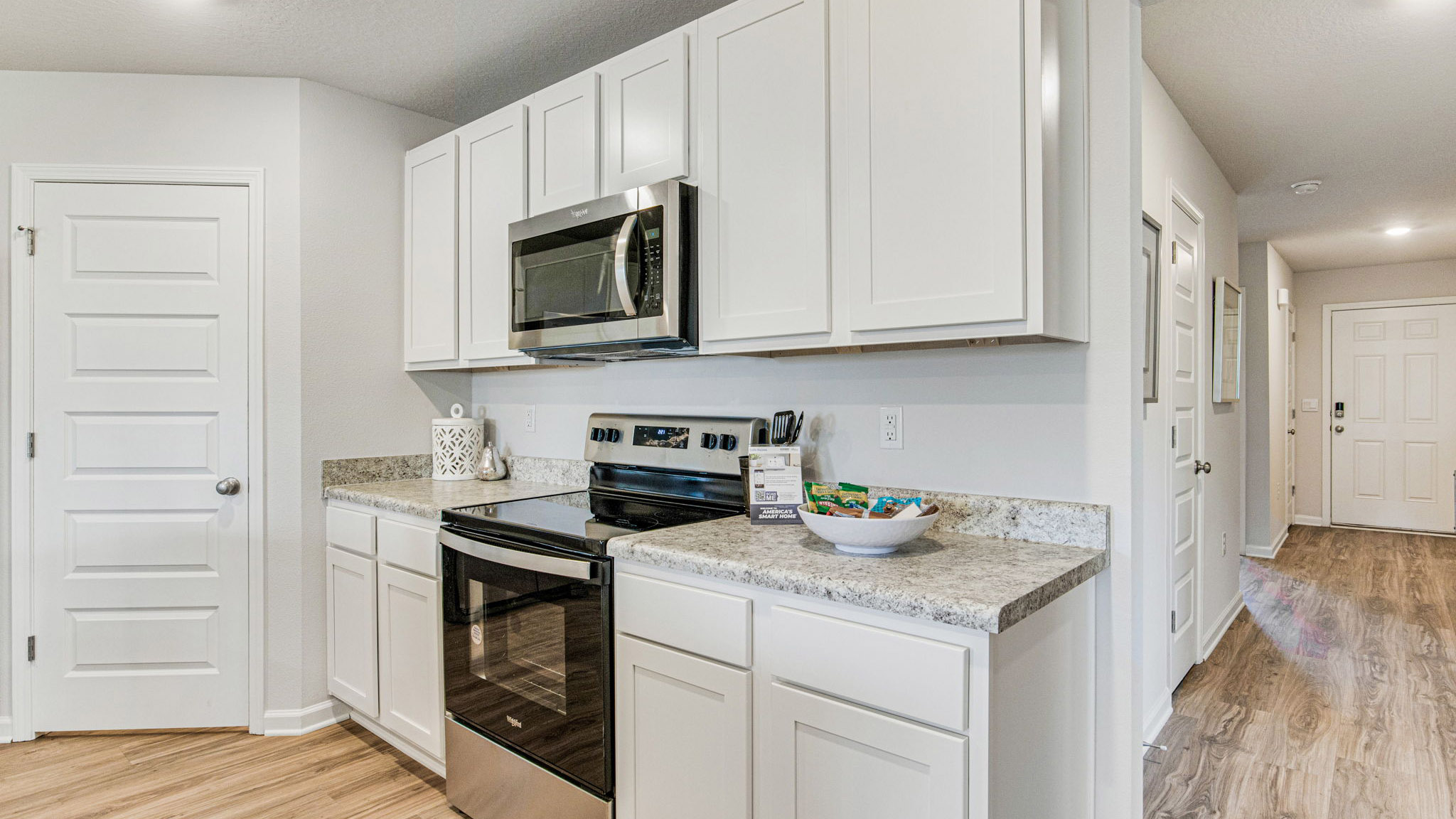 The Cali floorplan kitchen with white shaker cabinets and Formica countertops