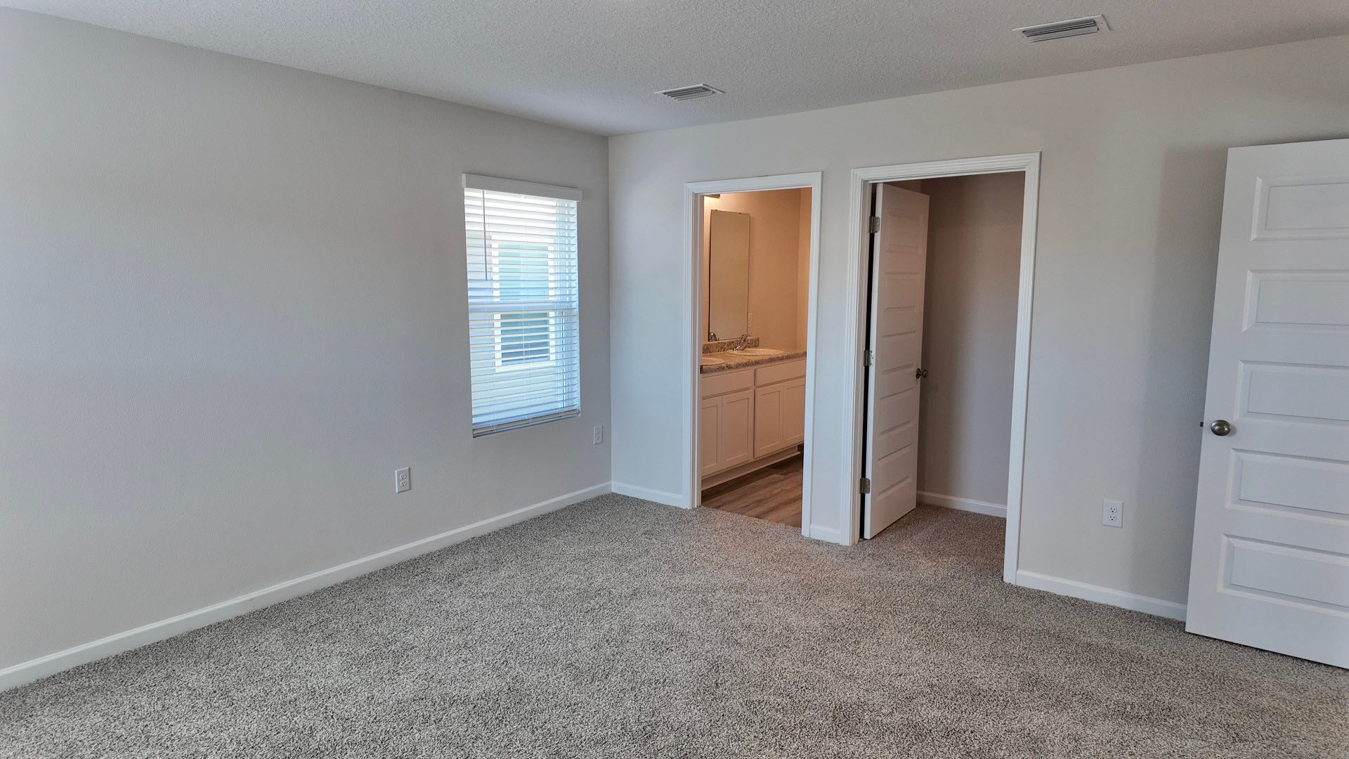 The Lismore floorplan primary bedroom with carpet flooring throughout