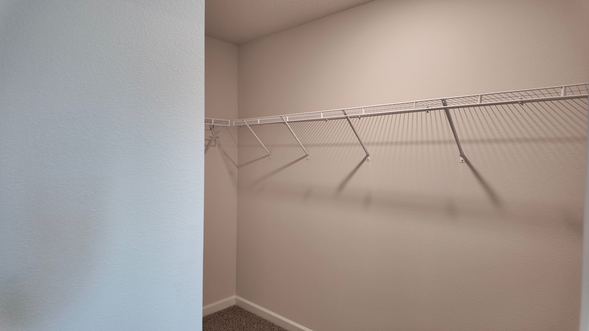 The Lismore floorplan primary bedroom closet with wire shelving