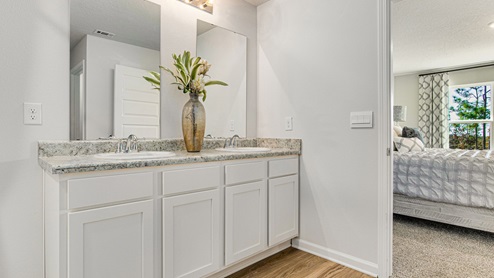 The Cali floorplan primary bathroom with dual vanity and Formica countertops