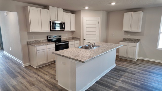 The Lakeside floorplan kitchen with white shaker cabinets and Formica countertops