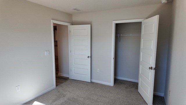 The Lakeside floorplan guest bedroom three with carpet throughout