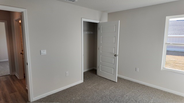 The Lakeside floorplan guest bedroom four with carpet throughout