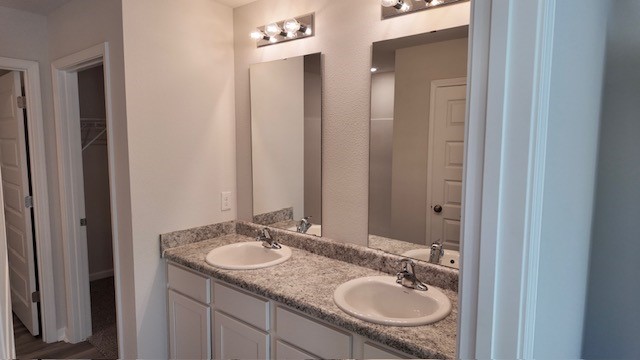 The Lakeside floorplan primary bathroom with dual vanity and Formica countertops