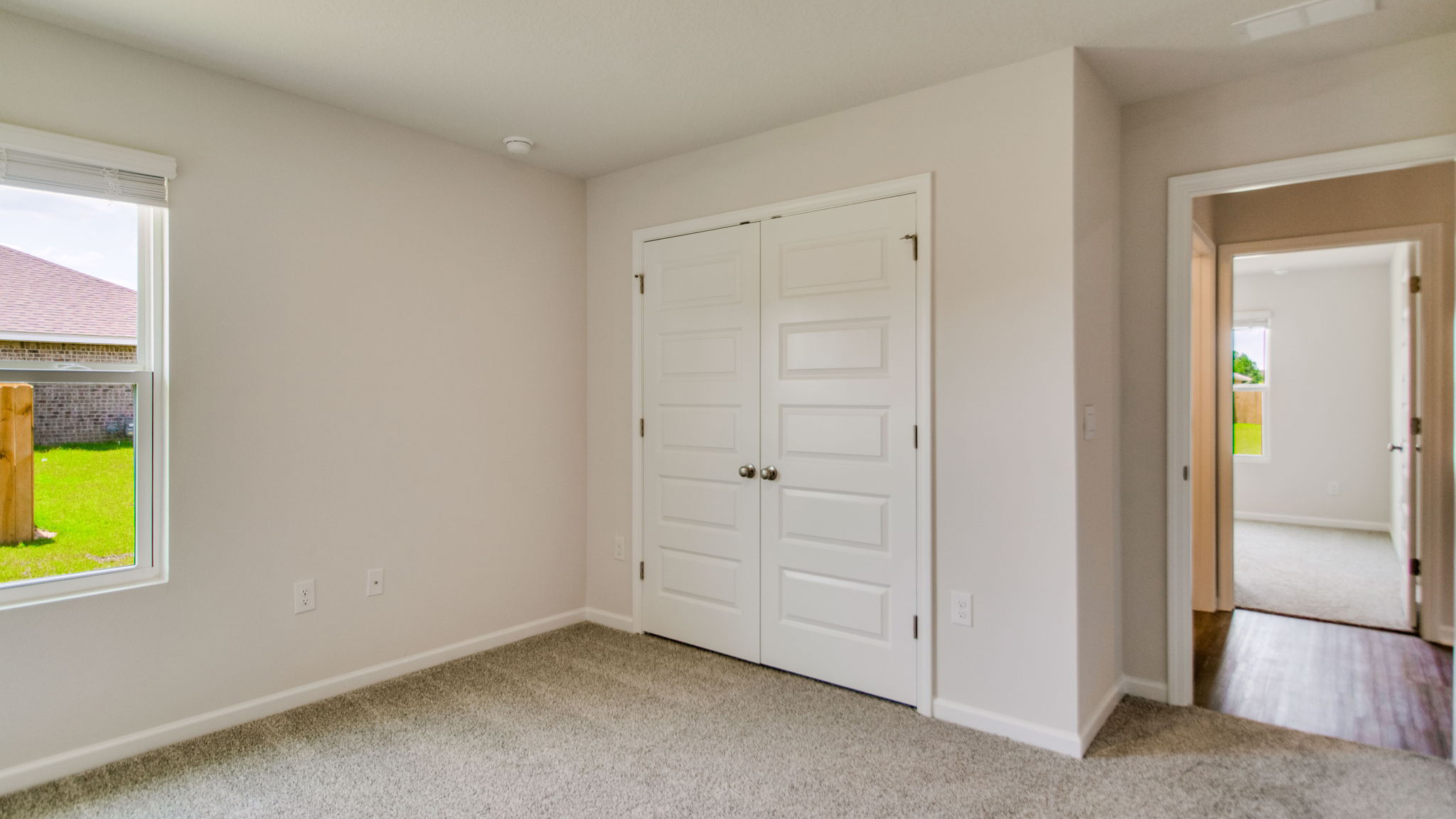 The Sawyer floorplan guest bedroom two with carpet throughout