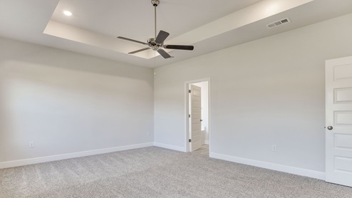 The Camden floorplan primary bedroom with carpet throughout