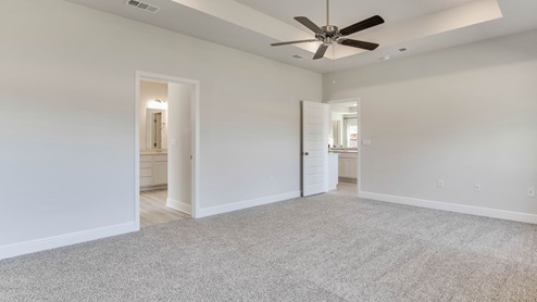 The Camden floorplan primary bedroom with tray ceilings