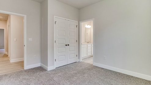 The Camden floorplan guest bedroom three with carpet throughout