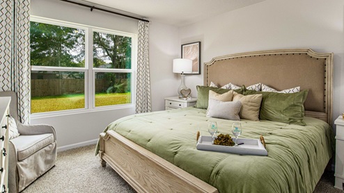 The Freeport primary bedroom with large window