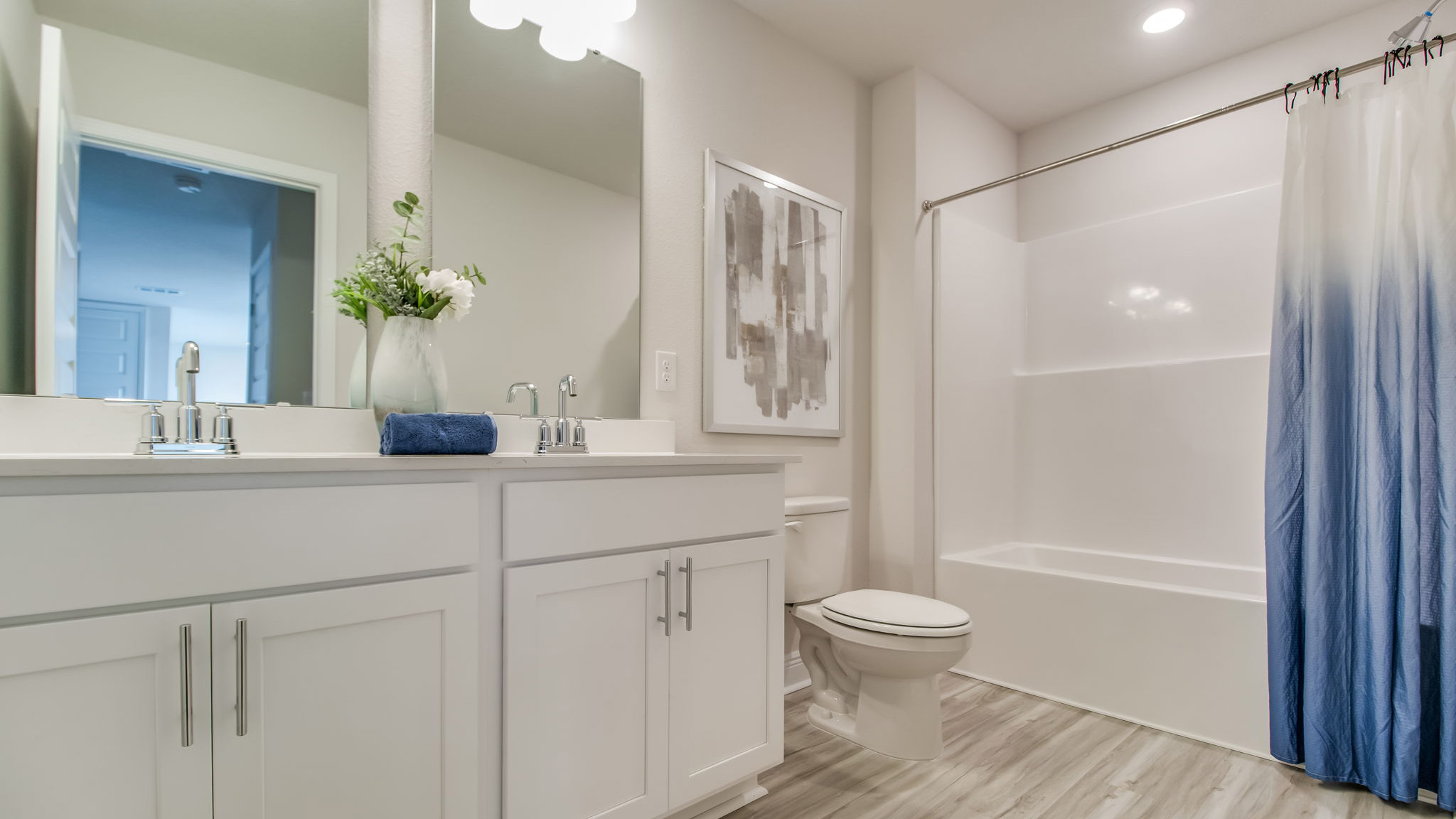 The Belfort floorplan guest bathroom with dual vanity and shower/tub combo