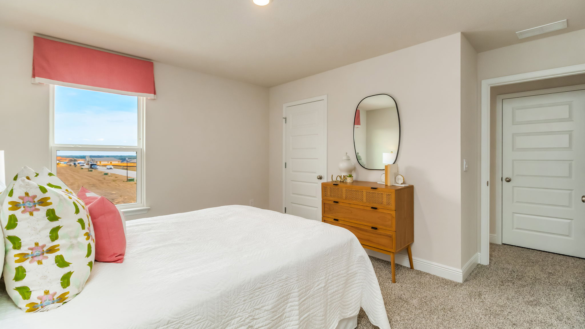 The Belfort floorplan guest bedroom two with one window and carpet throughout