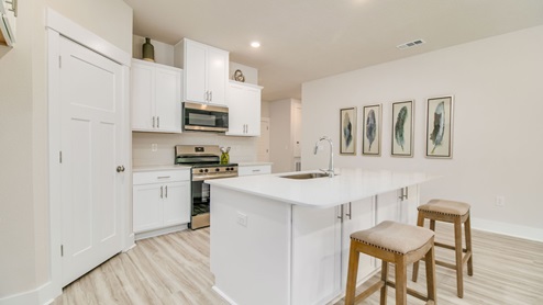 The Rhett kitchen with quartz countertops and stainless-steel appliances