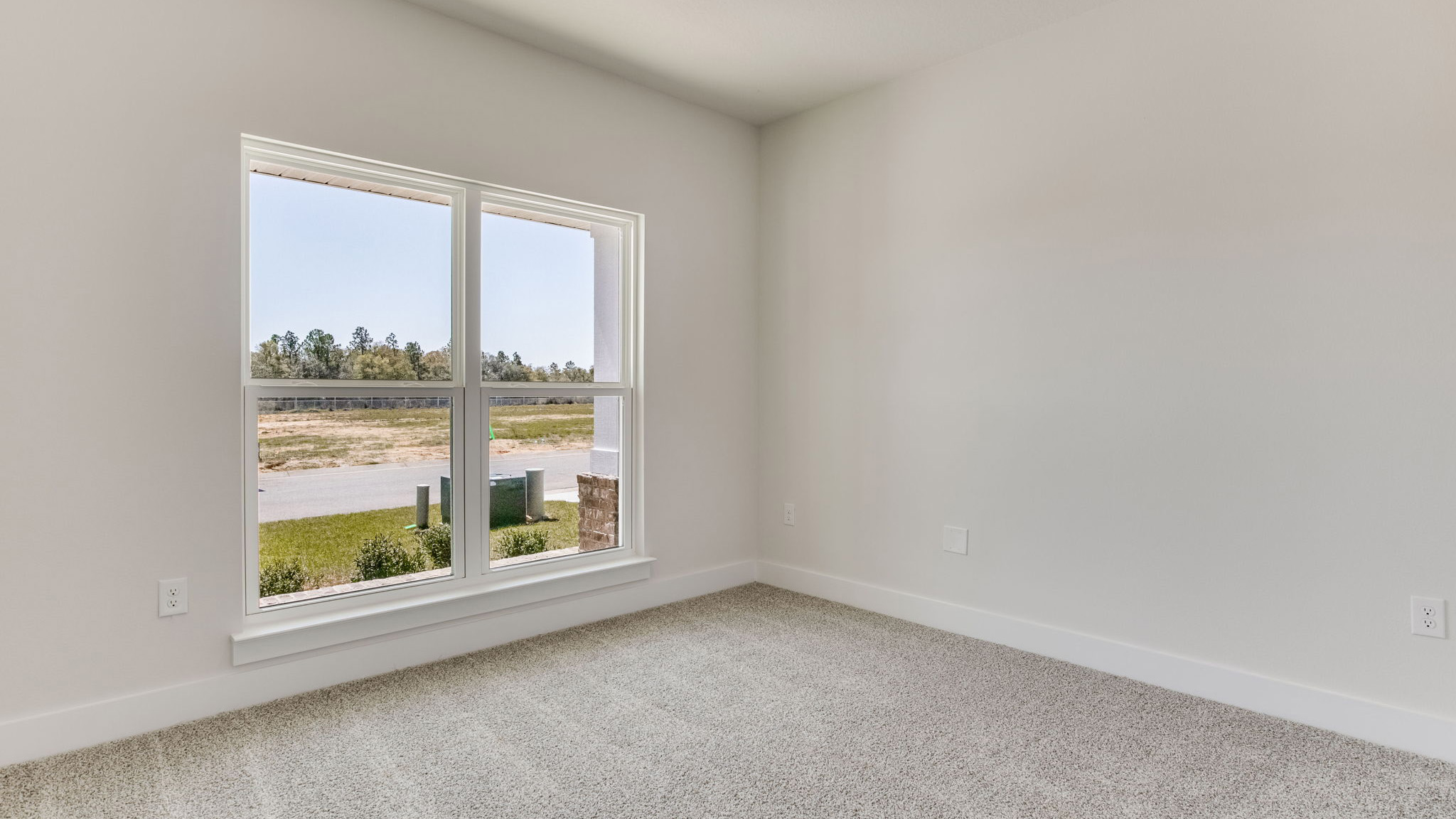 The Lamar floorplan guest bedroom one with carpet throughout