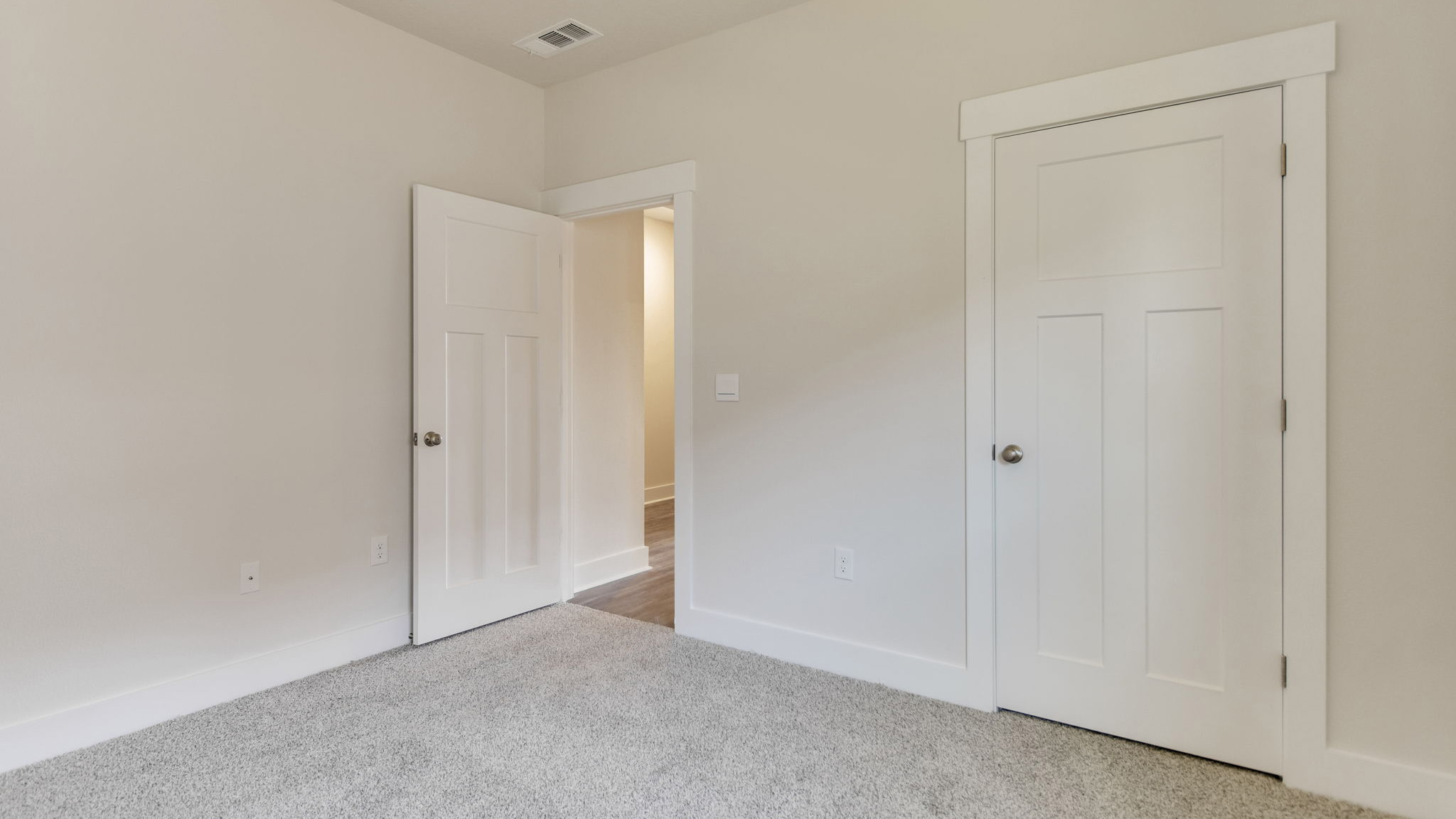 The Lamar floorplan guest bedroom two with carpet throughout
