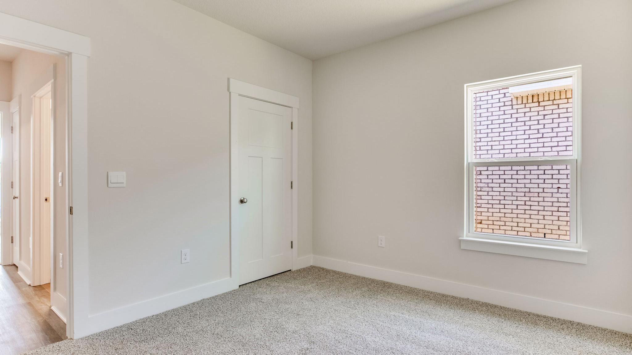 The Lamar floorplan guest bedroom two with carpet throughout
