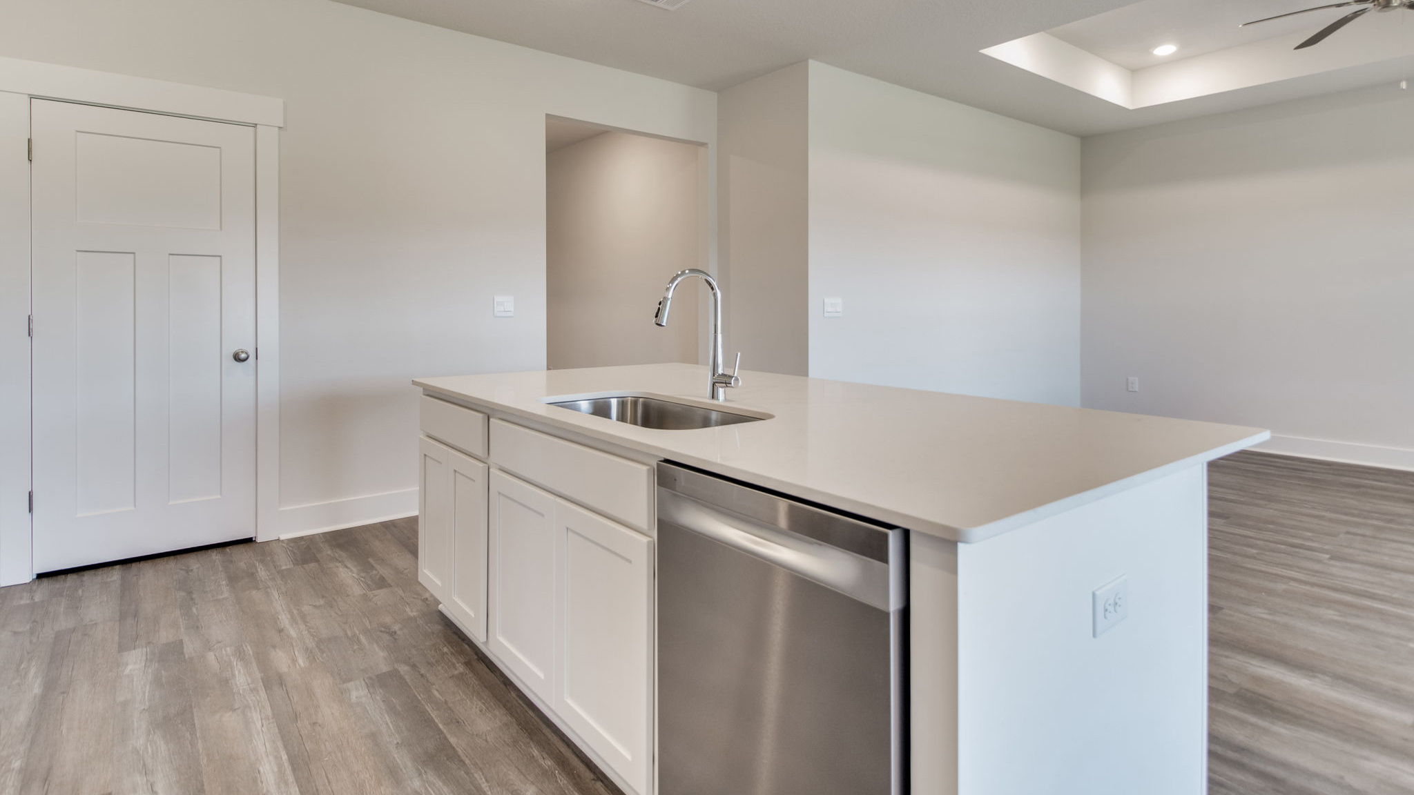 The Lamar floorplan kitchen island with quartz countertops and stainless-steel dishwasher