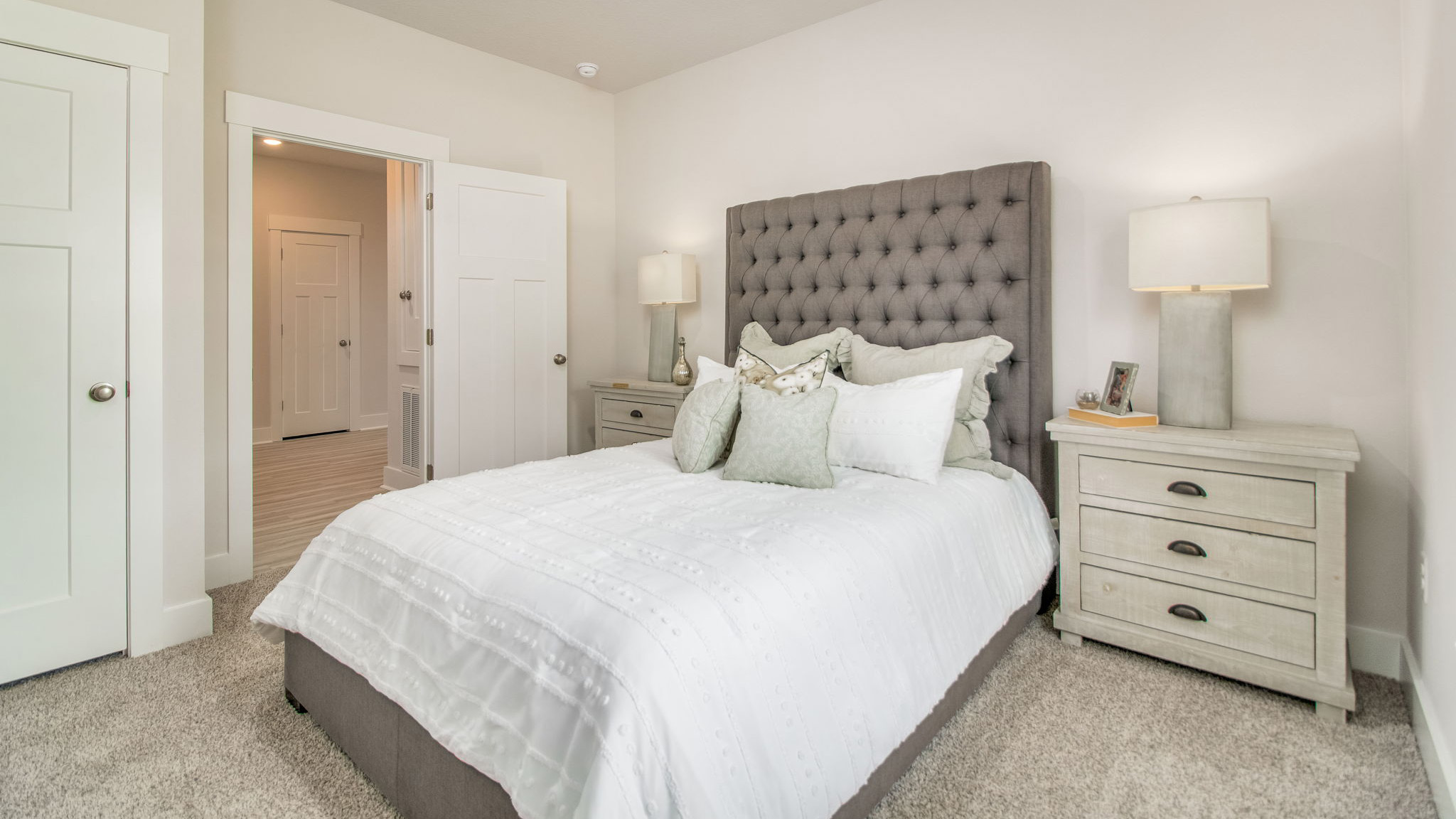 The Rhett floorplan guest bedroom one with carpet throughout