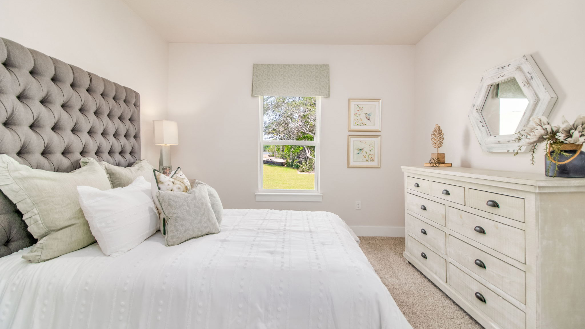 The Rhett floorplan guest bedroom one with carpet throughout