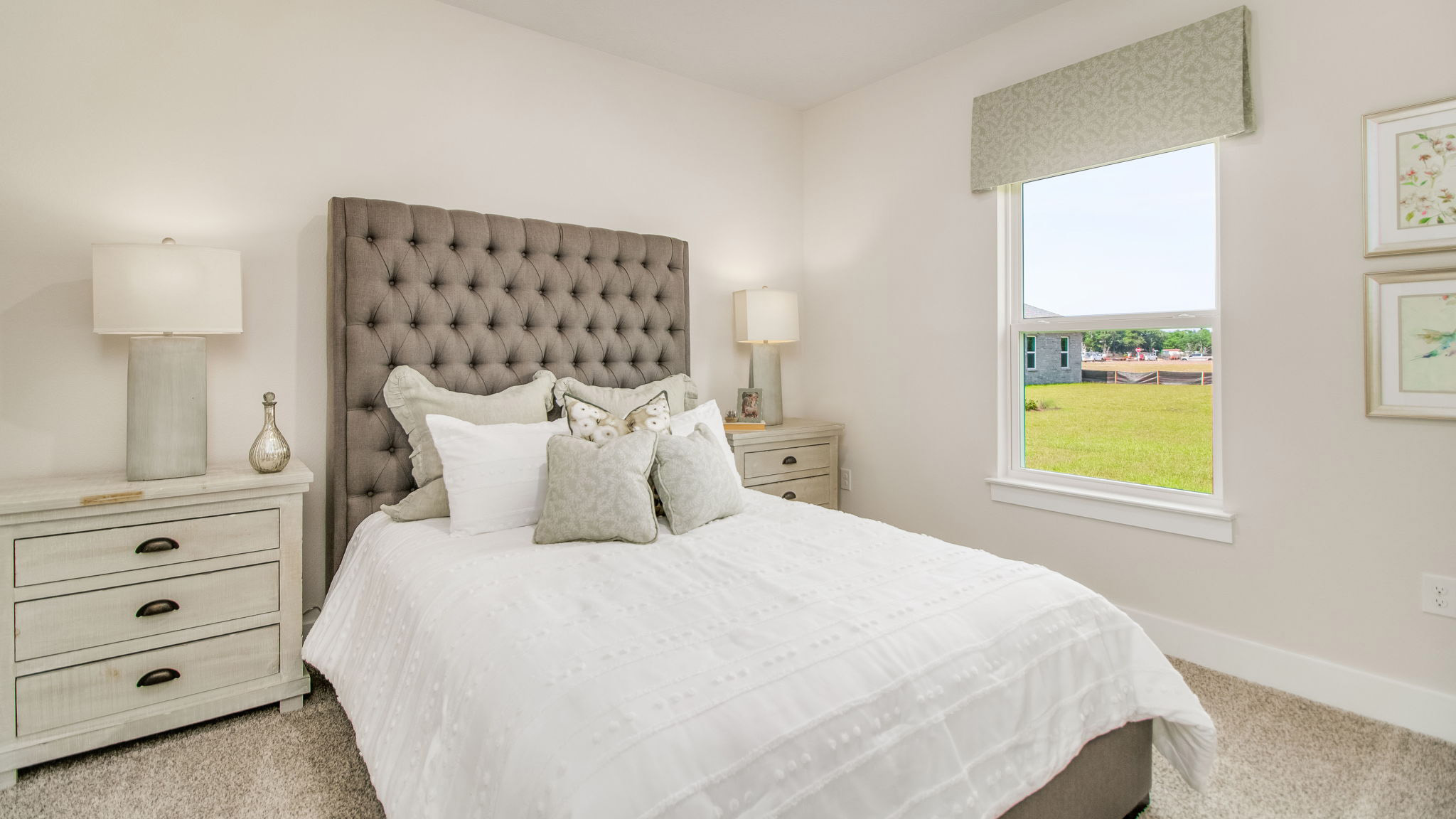 The Rhett floorplan guest bedroom one with carpet throughout