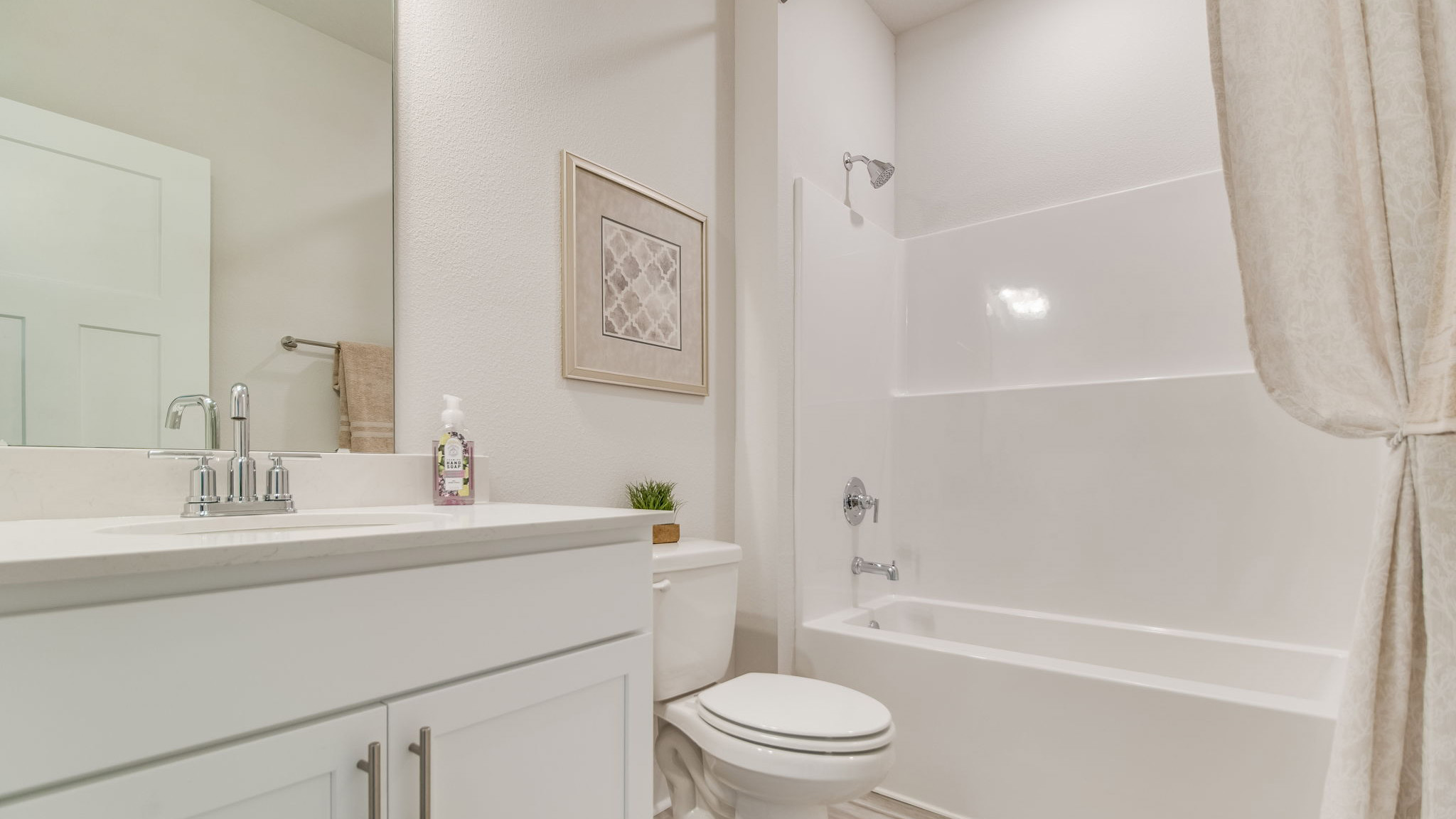 The Rhett floorplan guest bathroom with single vanity and quartz countertops