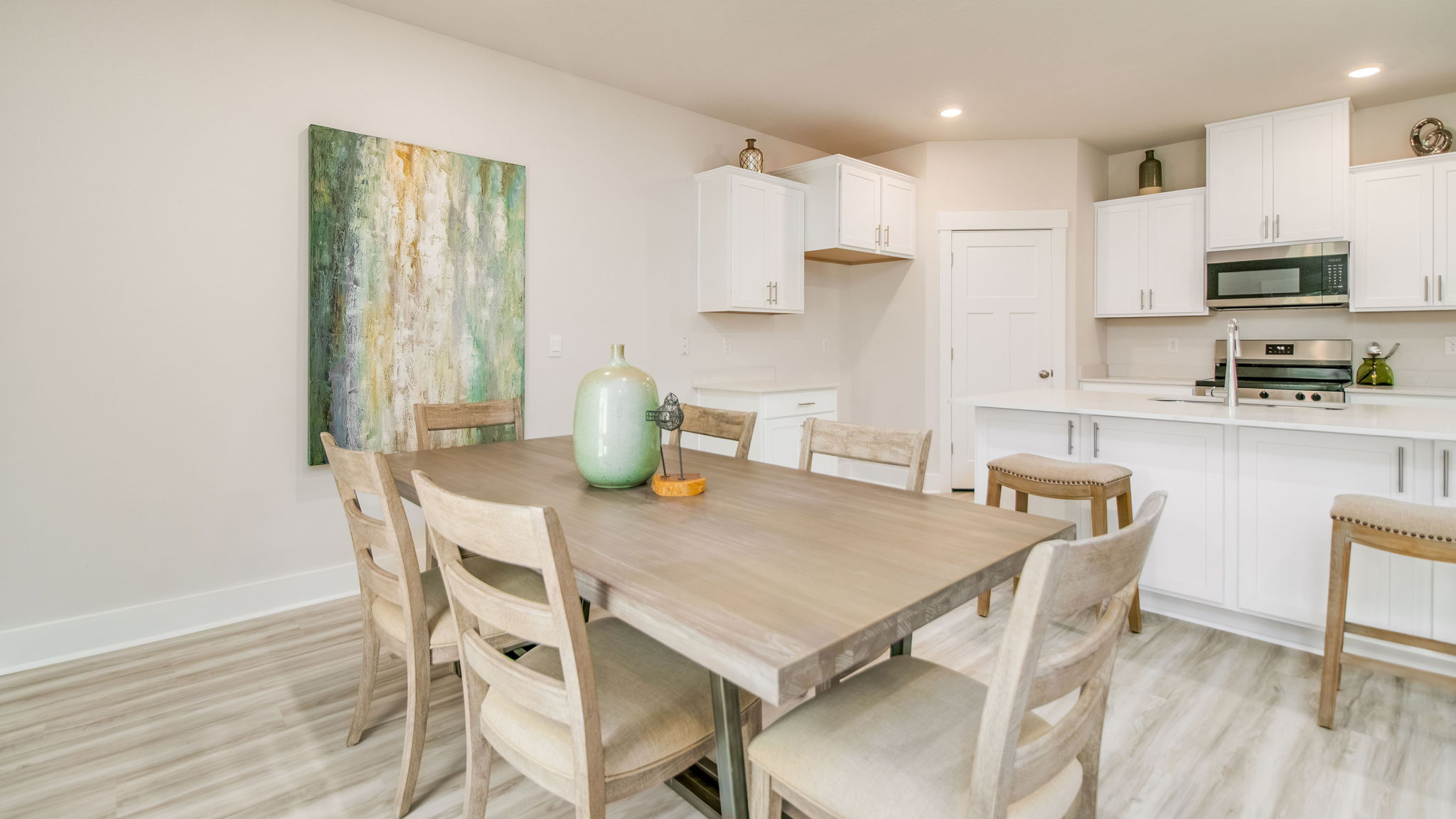 The Rhett floorplan open concept kitchen, dining and living room with EVP flooring throughout