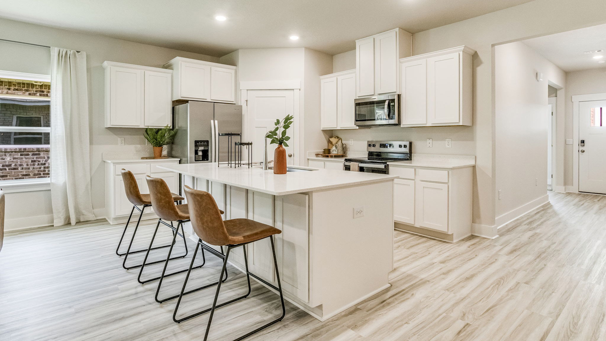 The Riverside floorplan kitchen with quartz countertops and white shaker cabinets