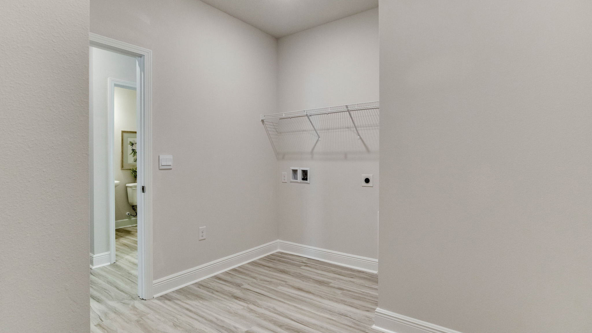 The Camden floorplan laundry room with EVP flooring throughout