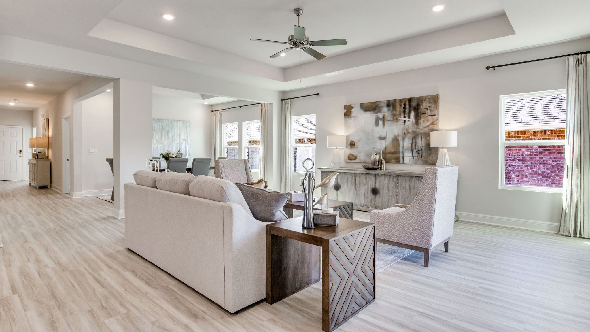 The Camden floorplan living and dining room with natural lighting from windows