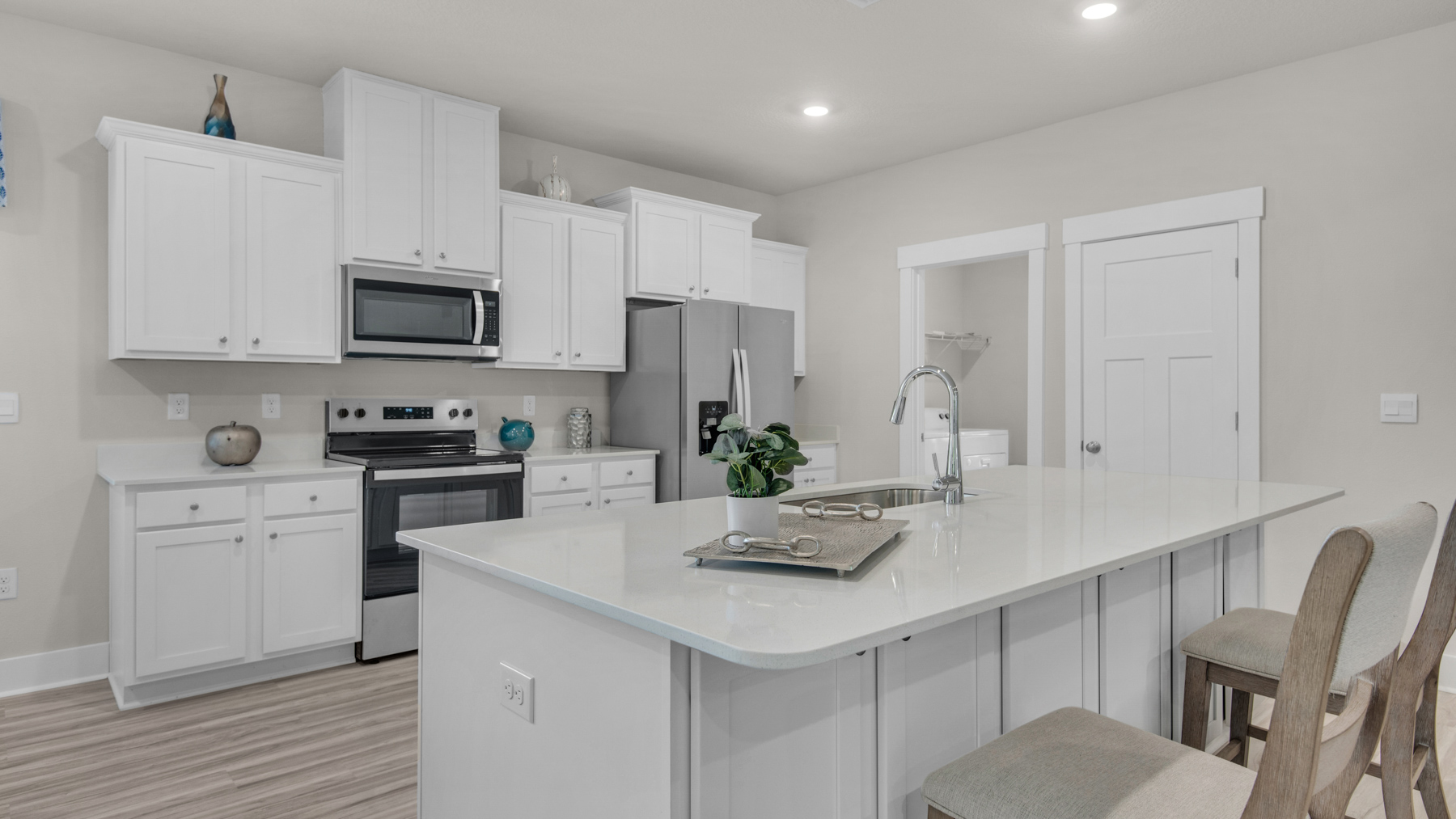 The Destin floorplan kitchen with white shaker cabinets and quartz countertops
