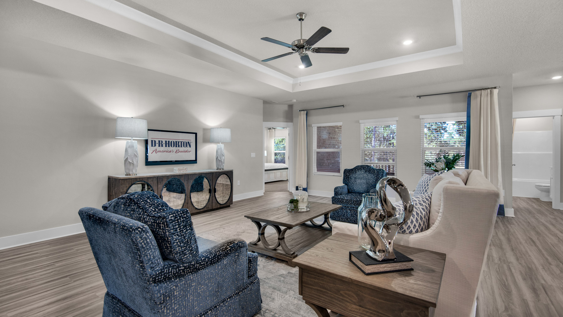 The Destin floorplan living room with tray ceilings and EVP flooring throughout