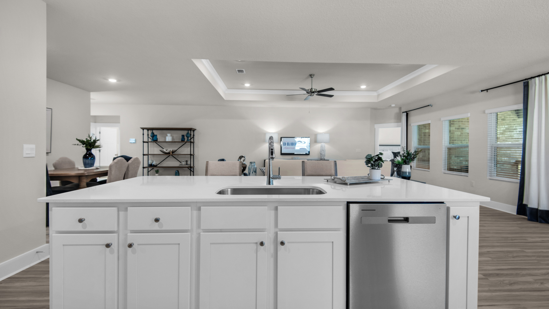 The Destin floorplan kitchen island and living room view