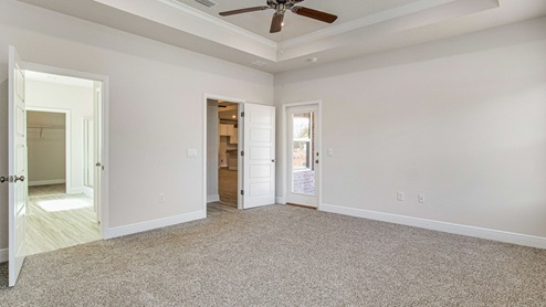 The McKenzie floorplan primary bedroom with trey ceilings