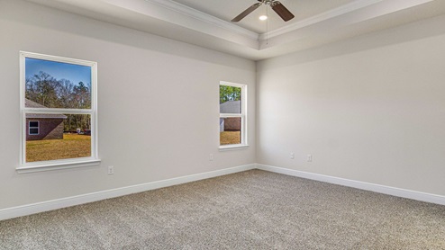 The McKenzie floorplan primary bedroom with trey ceiling