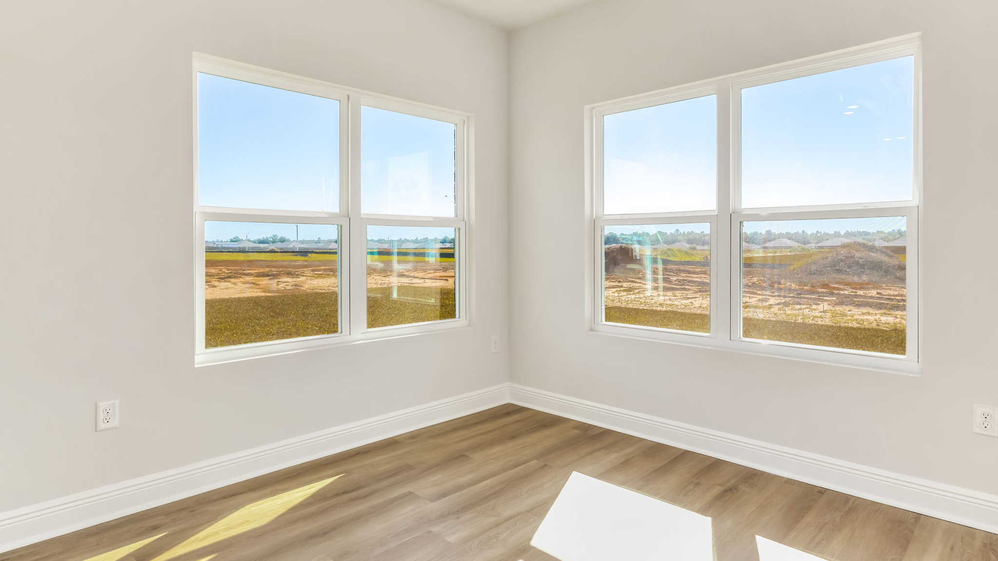 The Madison floorplan dining room with large windows and EVP flooring