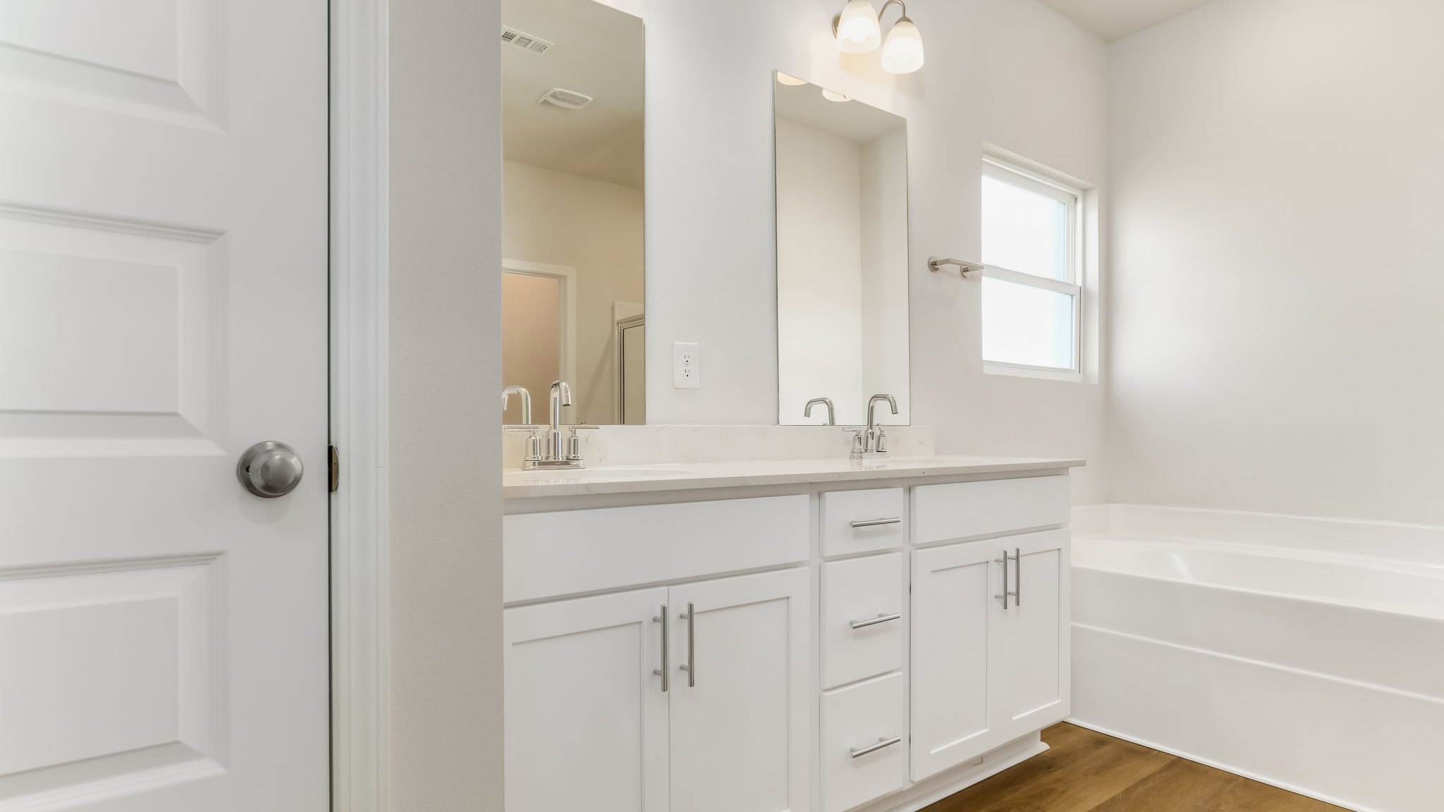The Madison floorplan primary bathroom with dual vanity and Quartz countertops