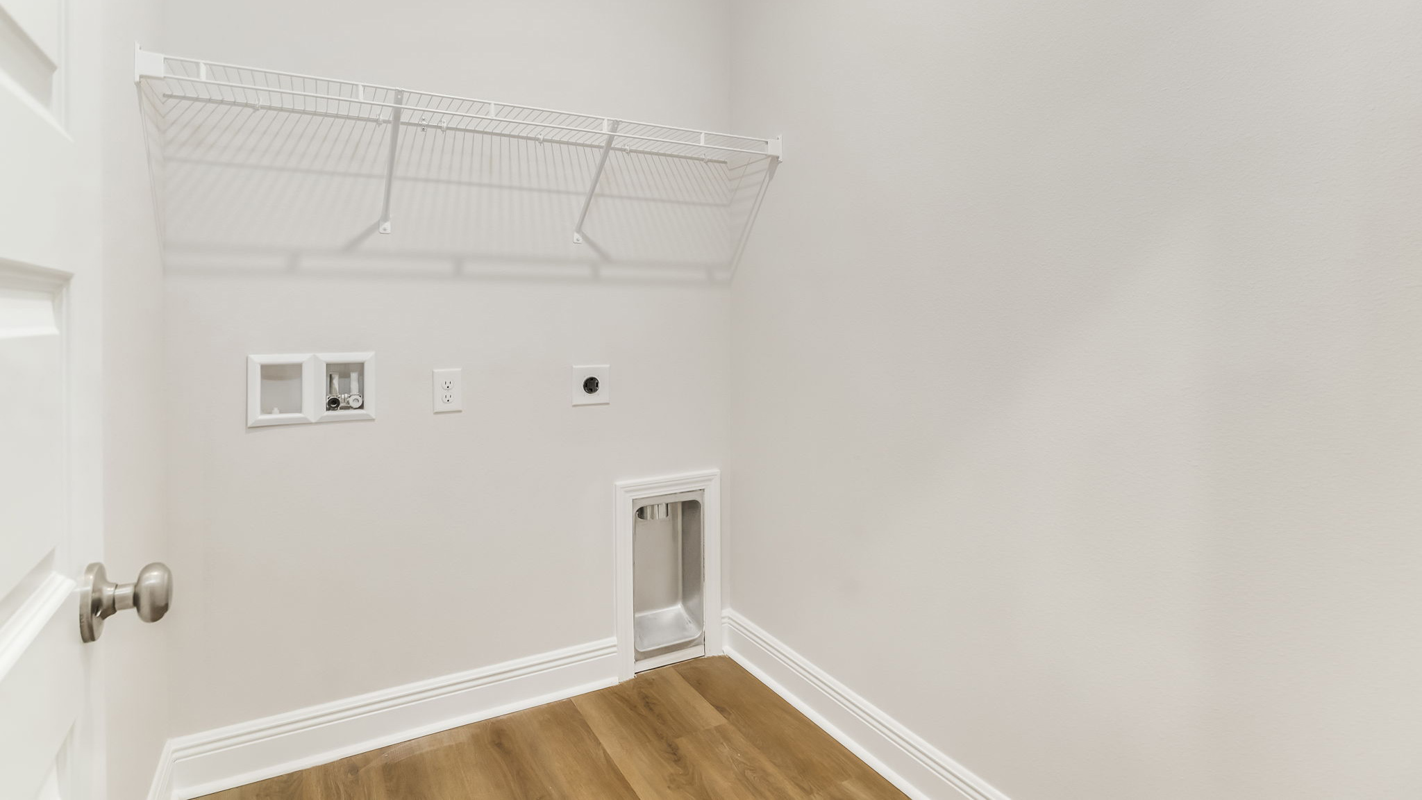 The Madison floorplan laundry room with EVP flooring throughout