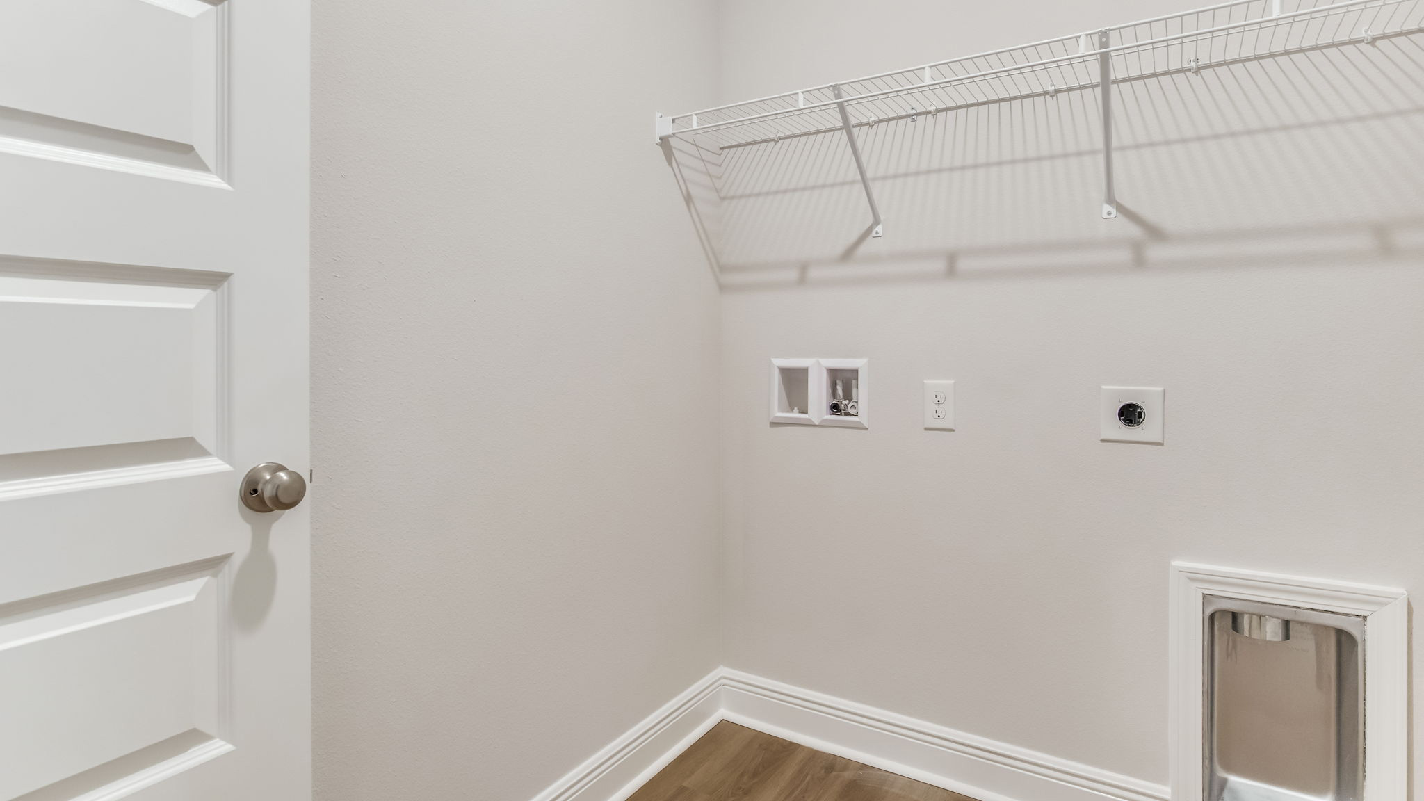The Madison floorplan laundry room with EVP flooring throughout