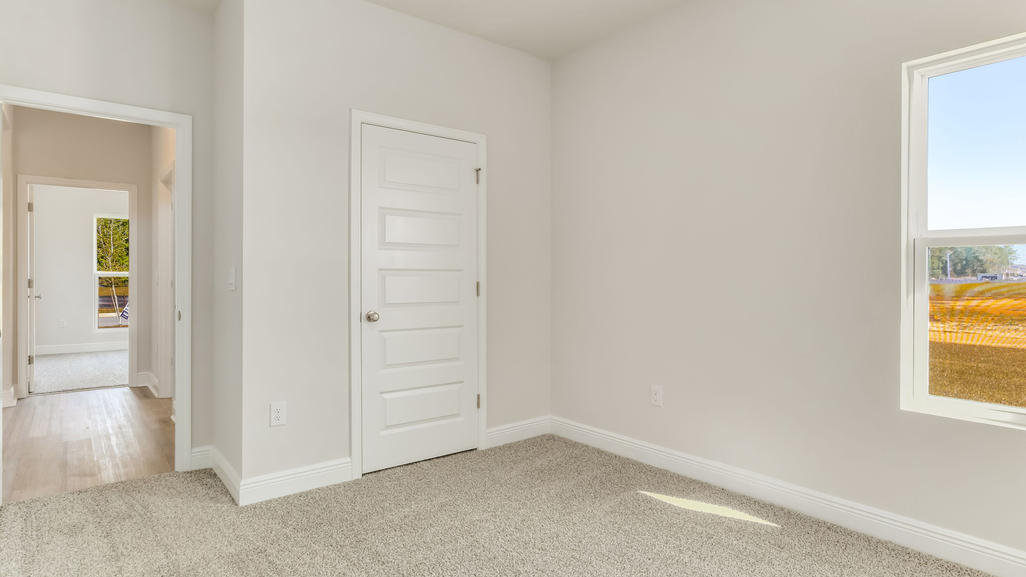 The Madison floorplan guest bedroom two with carpet throughout