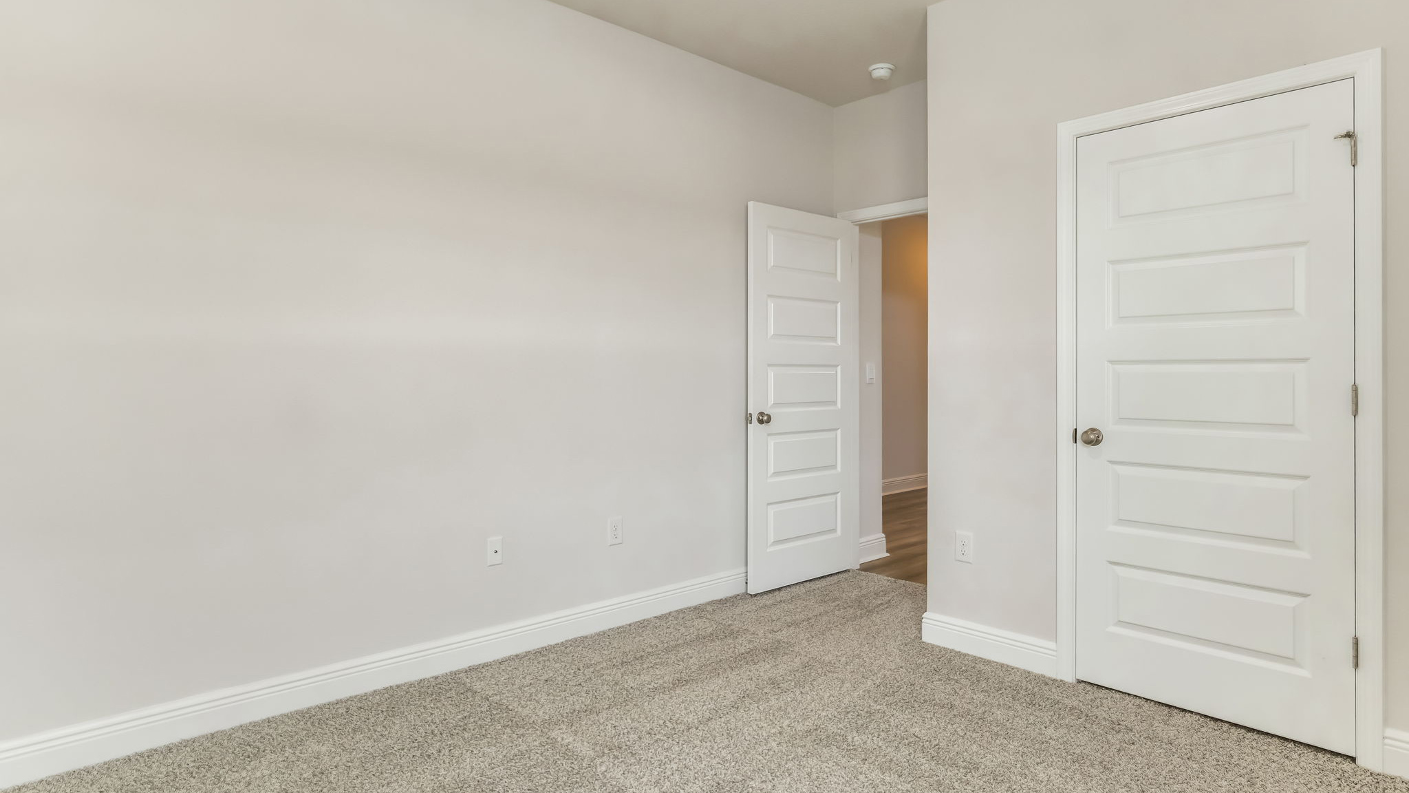 The Madison floorplan guest bedroom two with carpet throughout