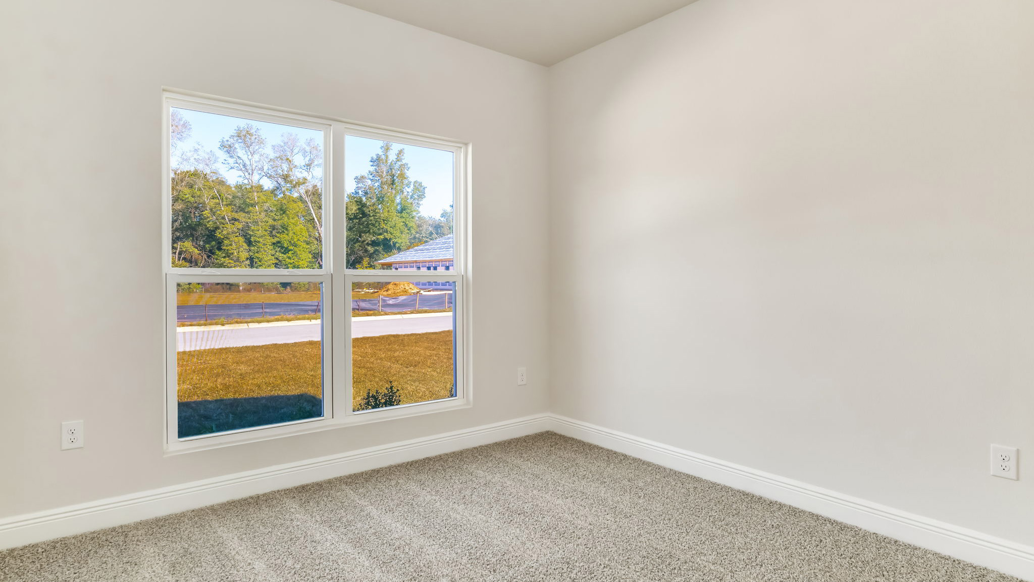The Madison floorplan guest bedroom three with carpet throughout