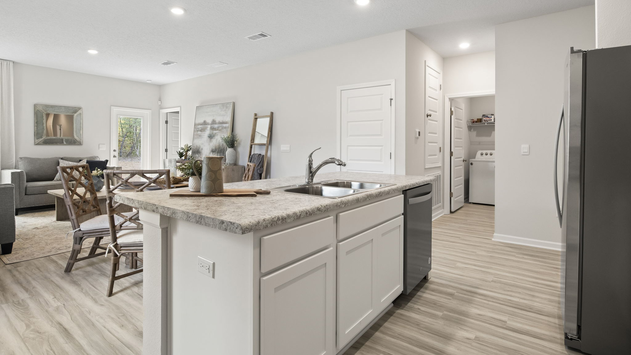 The Delilah floorplan open concept kitchen with EVP flooring throughout