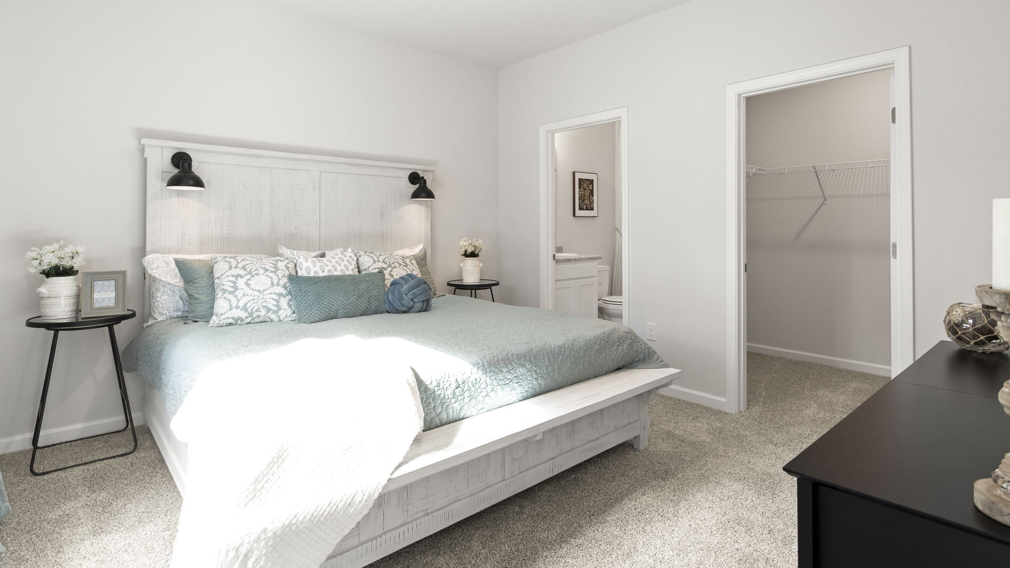 The Delilah floorplan primary bedroom with natural lighting