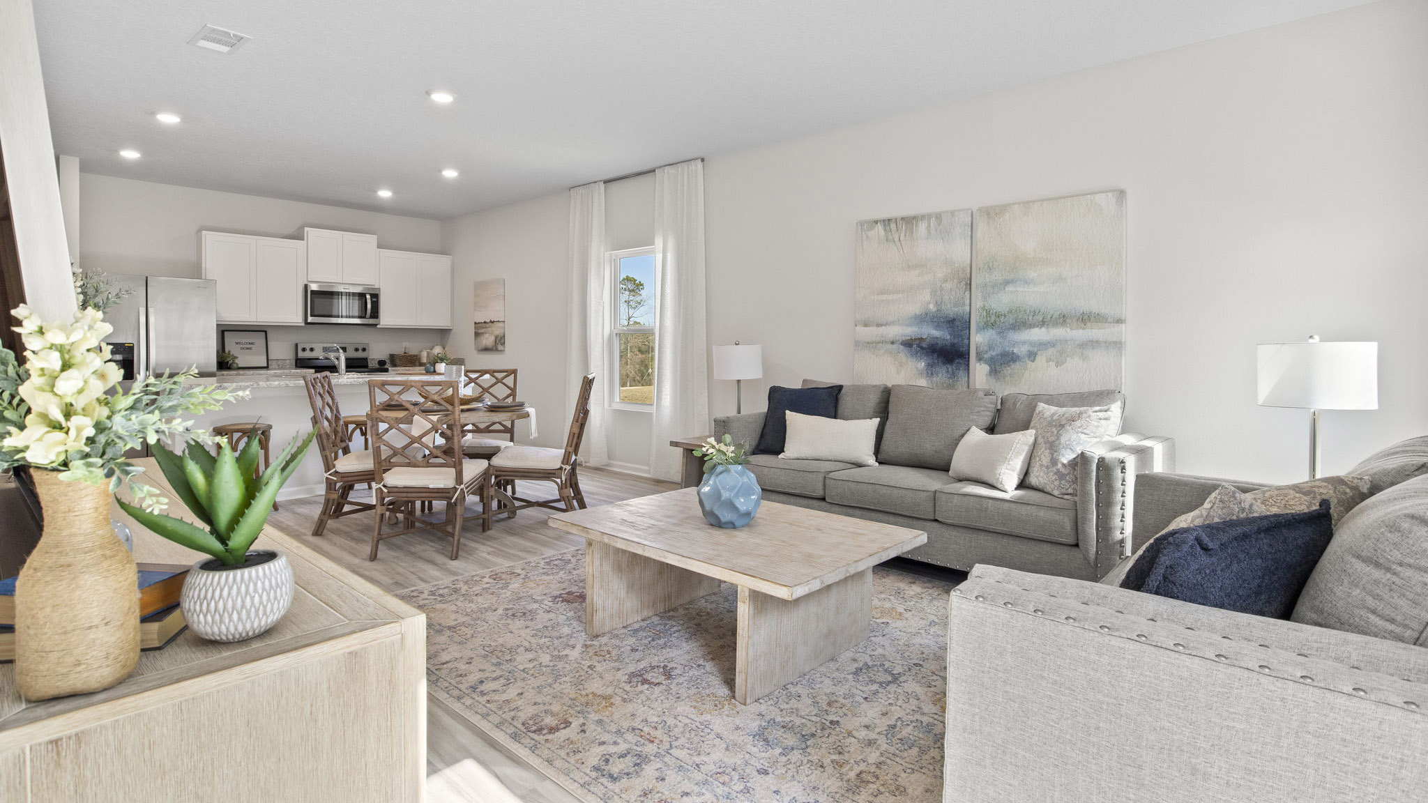 The Delilah floorplan open concept living and dining room with EVP flooring throughout