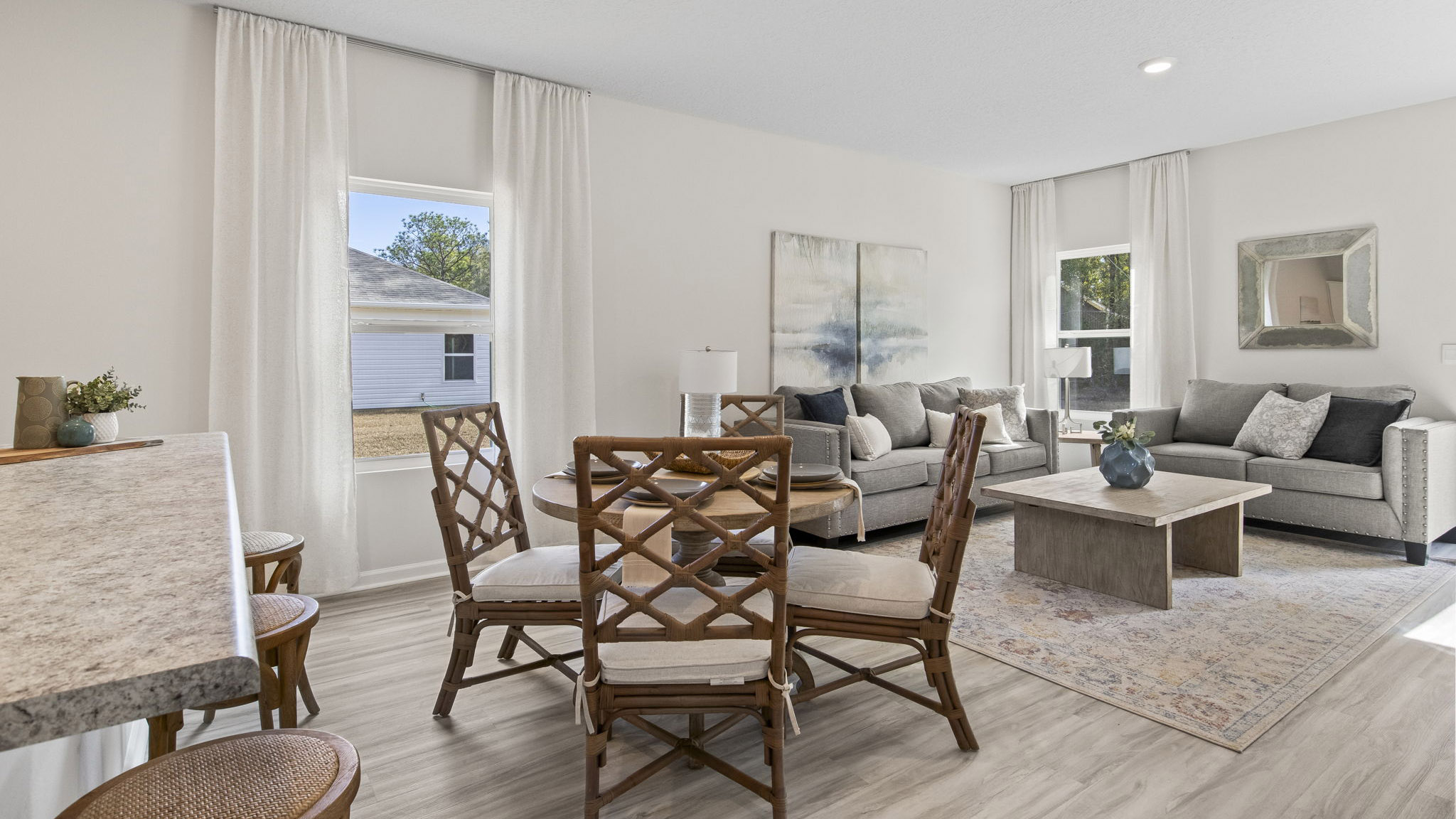 The Delilah floorplan open concept living and dining room with EVP flooring throughout