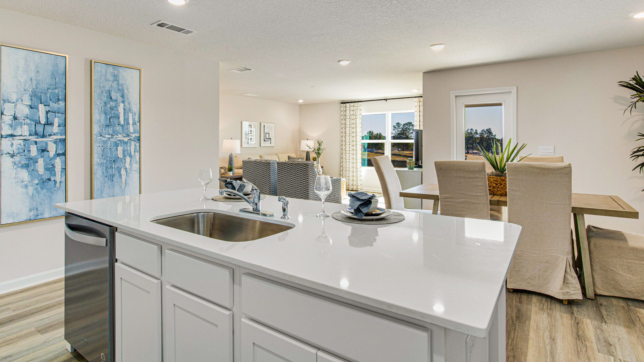 The Cali floorplan kitchen island with Quartz countertops and stainless-steel appliances