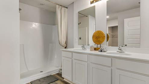 The Cali primary bathroom with double sinks and quartz countertops